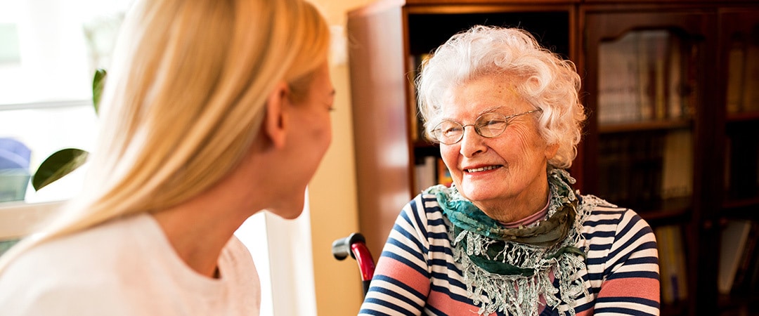 Social services worker helping an elderly woman set an appointment